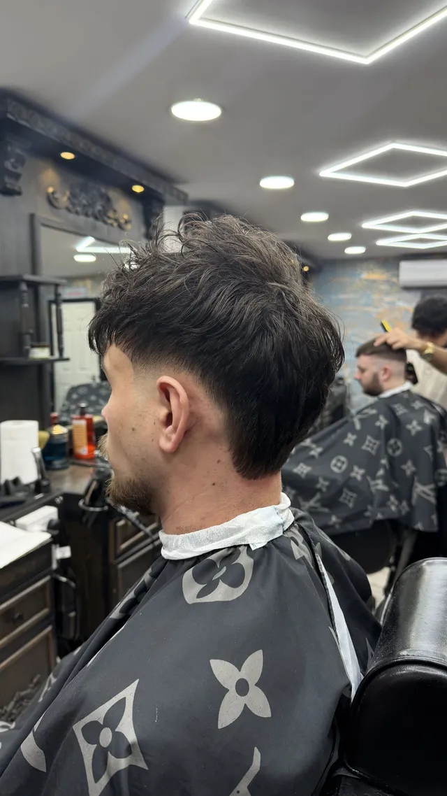 Side view of a dark textured haircut with neatly tapered sides in the Brotherhood shop