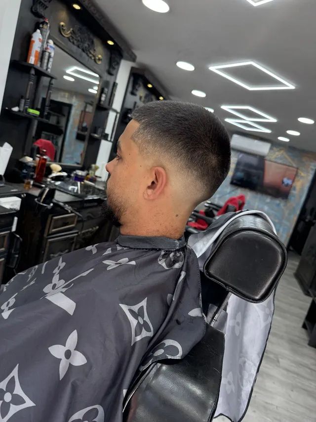 Short haircut showing a smooth blend at the back and sides in a Brotherhood barber chair
